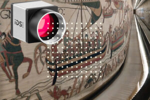 image of ids camera superimposed over background of tapestry